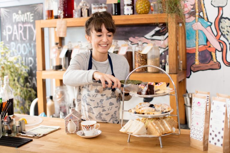 Woman selling cake in Bristol for a photo session for American Express