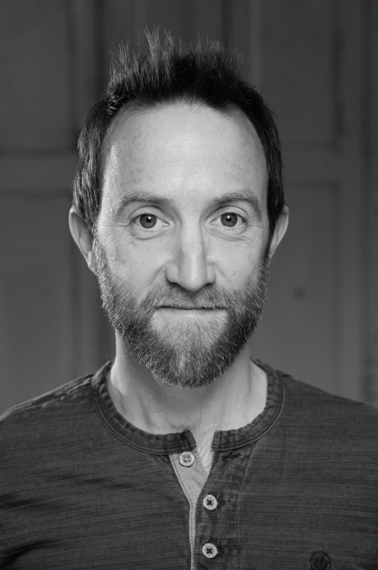 Image shows an actor headshot photo of Nik Howden, Bristol