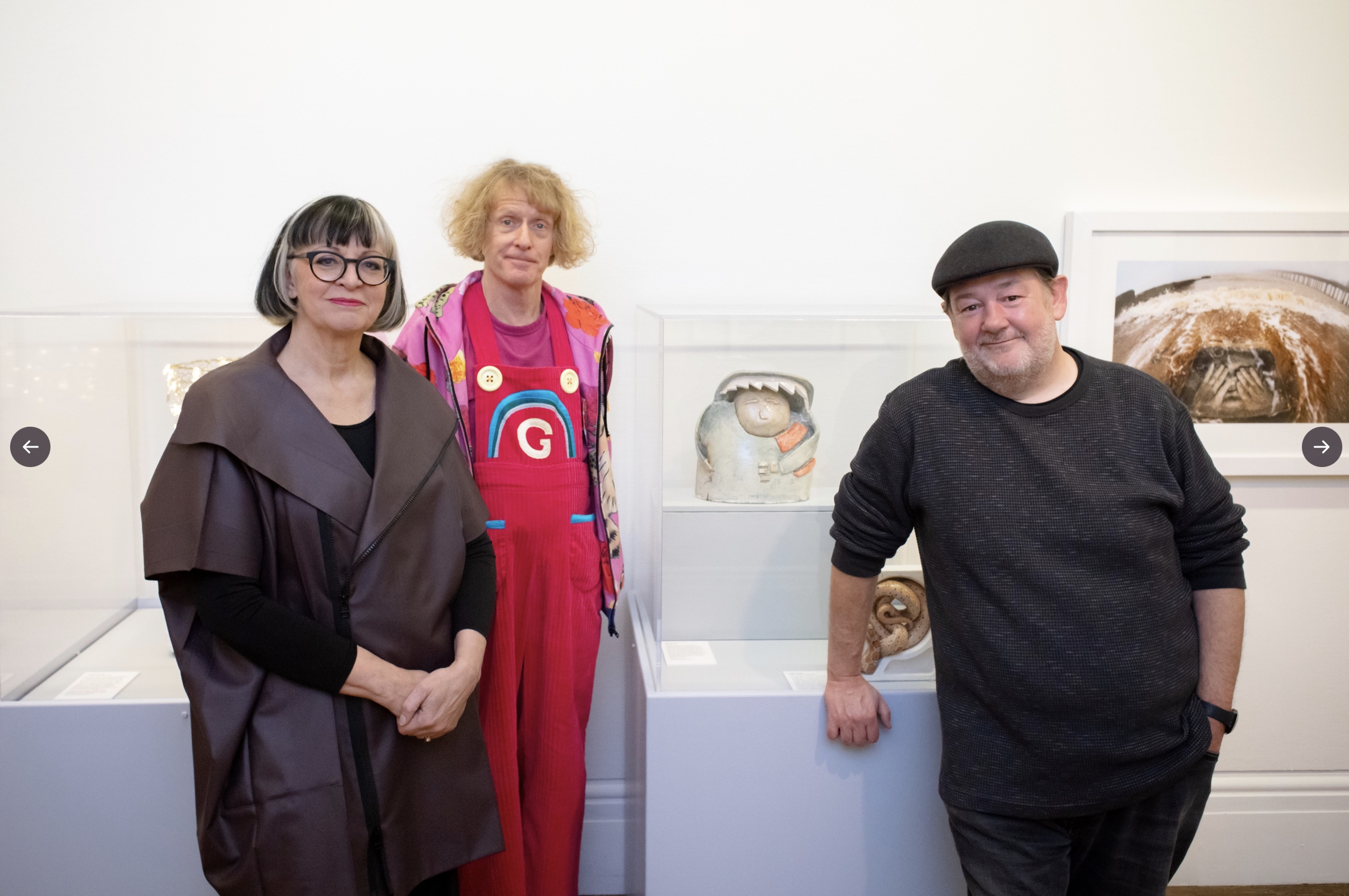 Johnny Vegas standing with Grayson Perry and Philippa Perry at Grayson's Art Club exhibition at Bristol Museum 2022